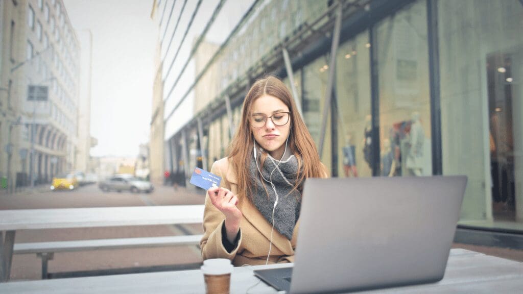 woman on laptop with bank card